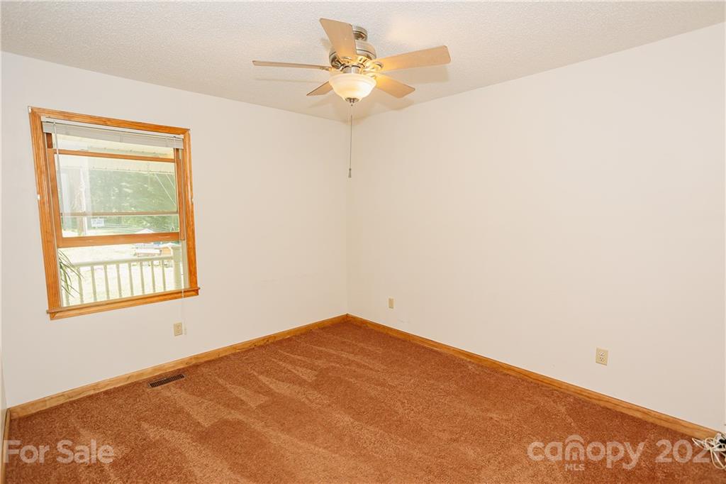 507 Vision Road Canton, NC 28716 - Photo 22 of 39 a view of an empty room with a window
