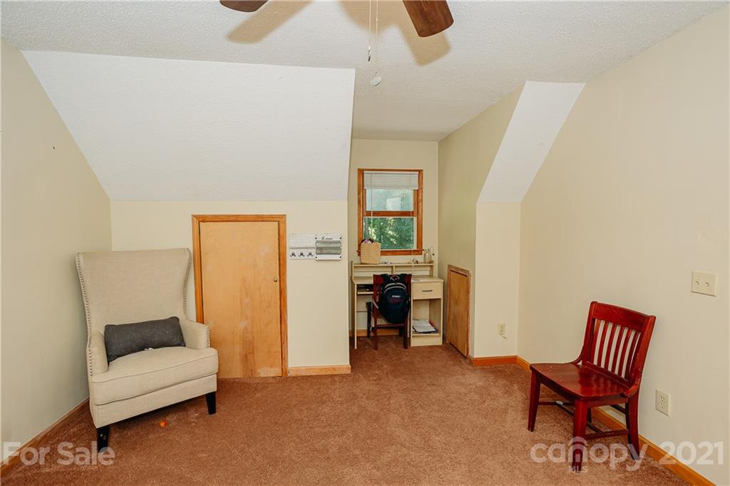 507 Vision Road Canton, NC 28716 - Photo 26 of 39 a bedroom with furniture and a chair