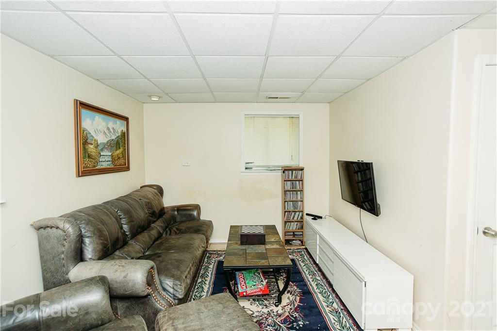 507 Vision Road Canton, NC 28716 - Photo 28 of 39 a living room with furniture and a flat screen tv