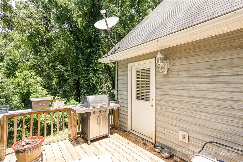 507 Vision Road Canton, NC 28716 - Photo 35 of 39 a view of a patio with table and chairs and wooden floor