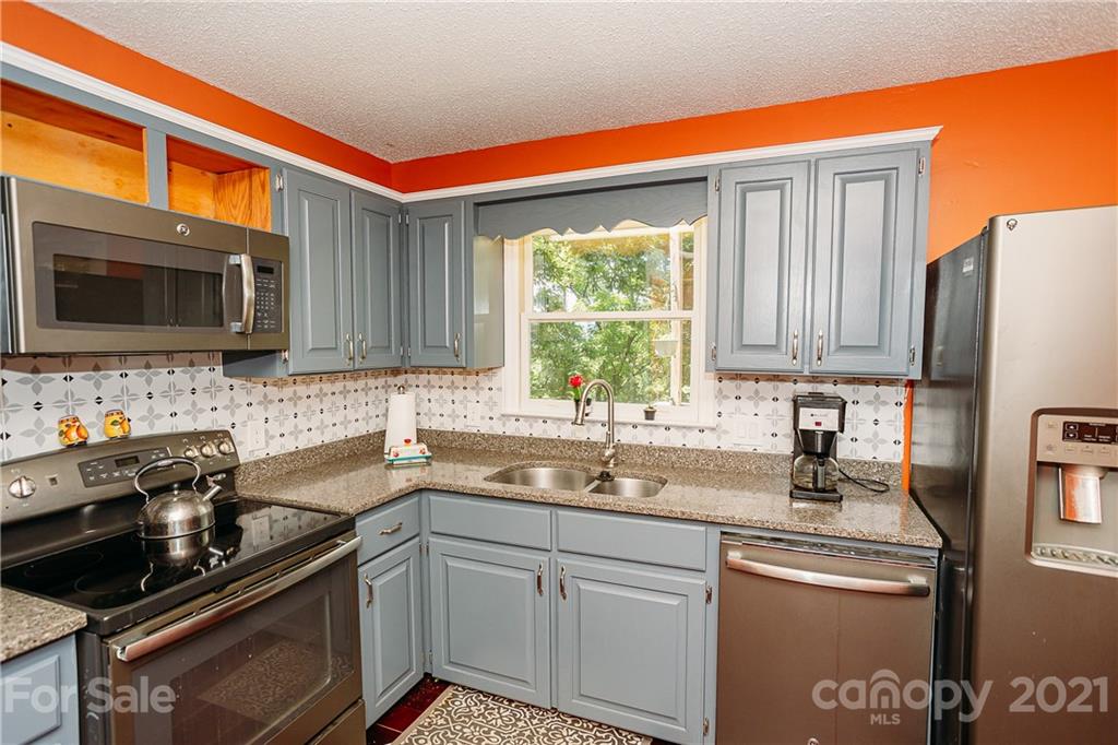 507 Vision Road Canton, NC 28716 - Photo 10 of 39 a kitchen with stainless steel appliances granite countertop a sink stove and microwave