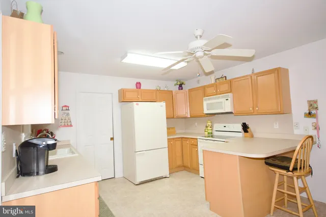 a kitchen with a sink appliances and cabinets