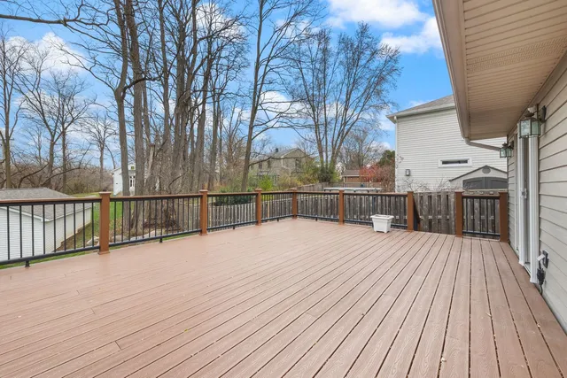 a view of balcony with wooden floor and fence