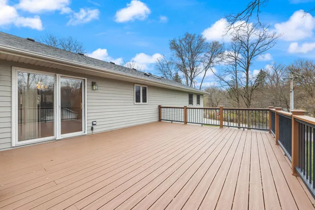 a balcony with wooden floor and fence