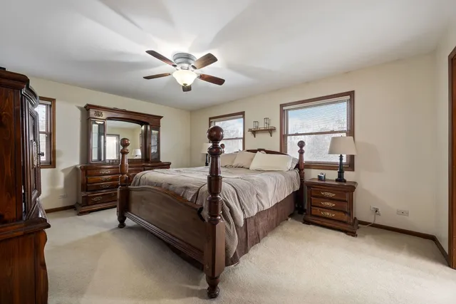 a spacious bedroom with a bed and a chandelier