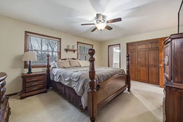 a spacious bedroom with a bed and a chandelier