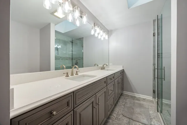 a bathroom with a double vanity sink and a mirror