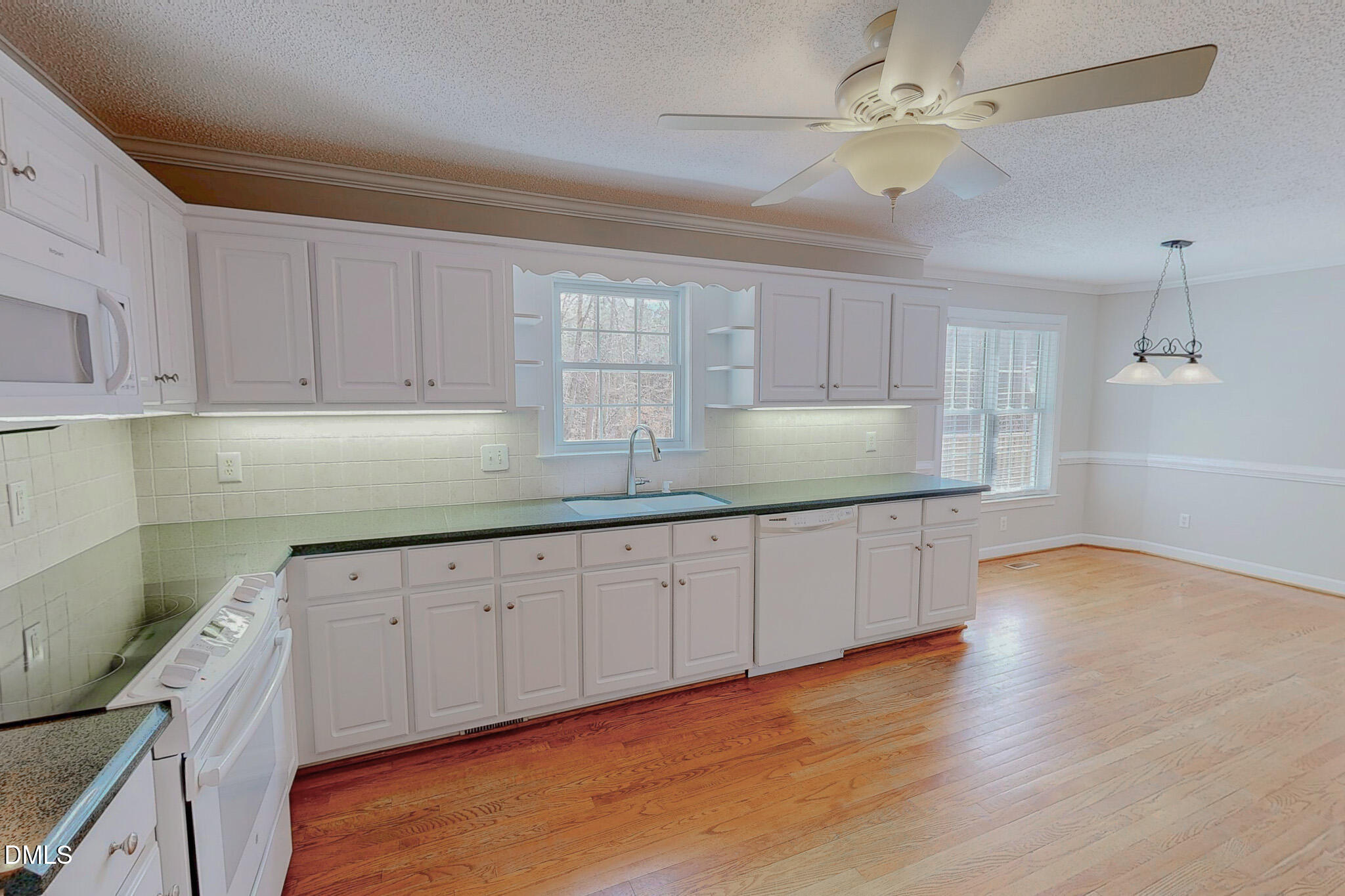 202 Equestrian Chase Rougemont, NC 27572 - Photo 4 of 54 a kitchen with granite countertop a stove a sink and cabinets
