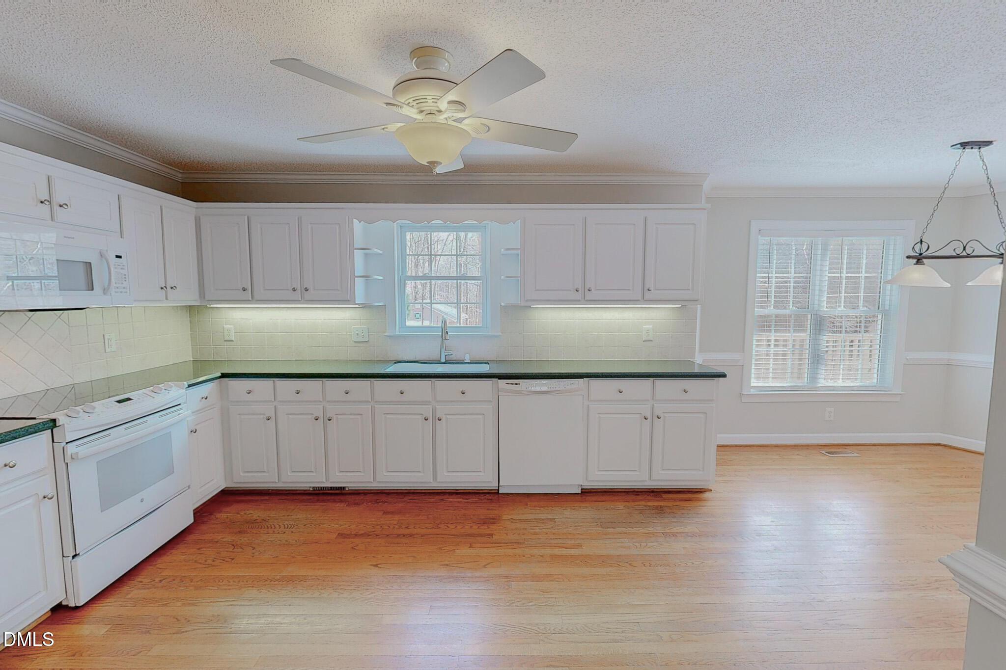 202 Equestrian Chase Rougemont, NC 27572 - Photo 50 of 54 a kitchen with granite countertop white cabinets a sink and dishwasher