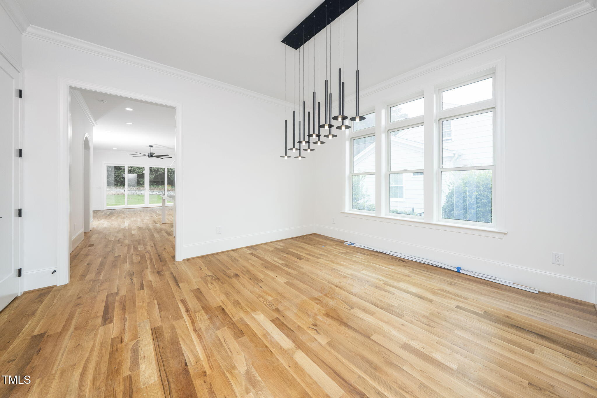 1330 Duplin Road Raleigh, NC 27607 - Photo 11 of 53 a view of an empty room with wooden floor and a window