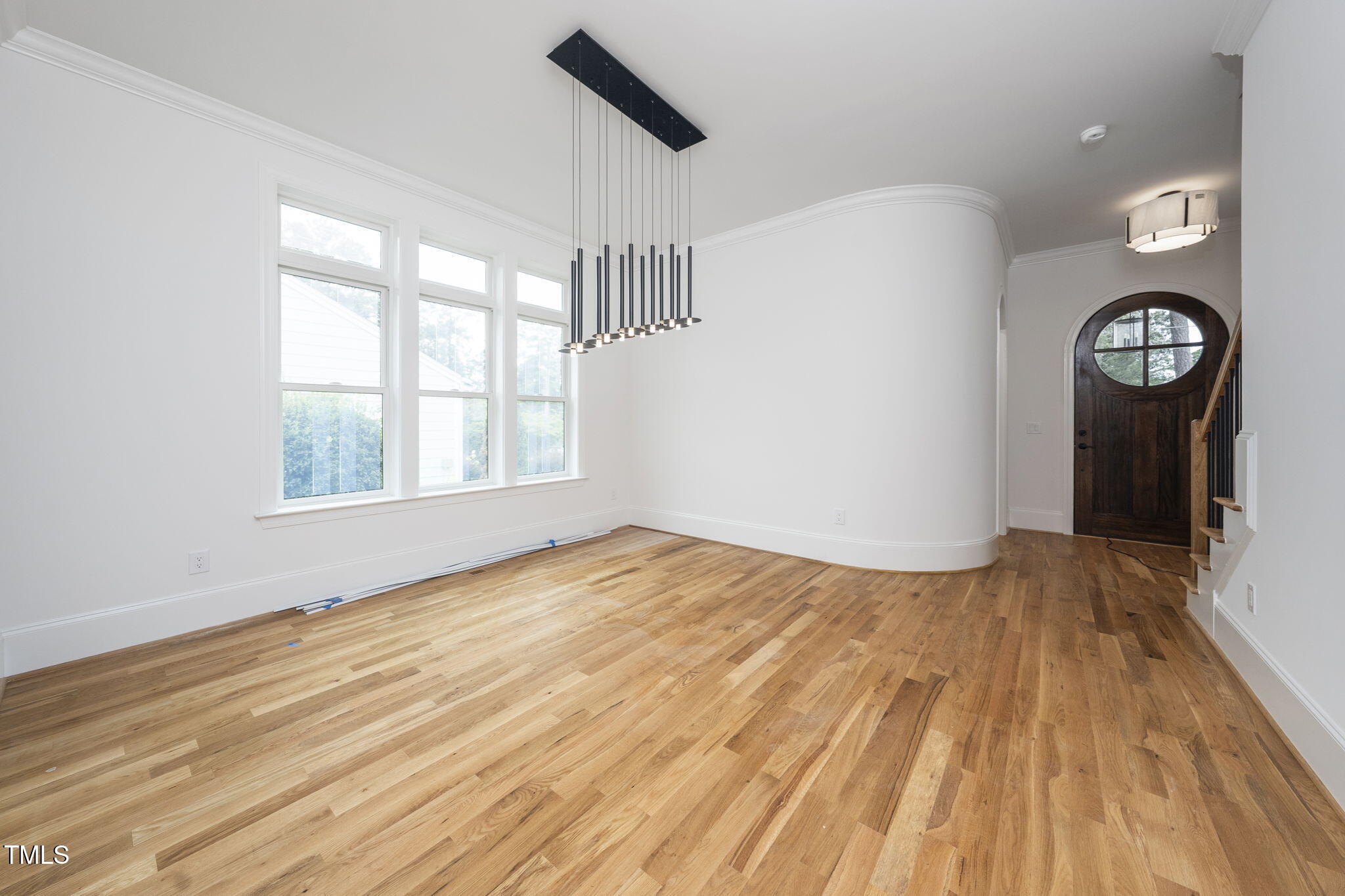 1330 Duplin Road Raleigh, NC 27607 - Photo 13 of 53 a view of an empty room with wooden floor and a window