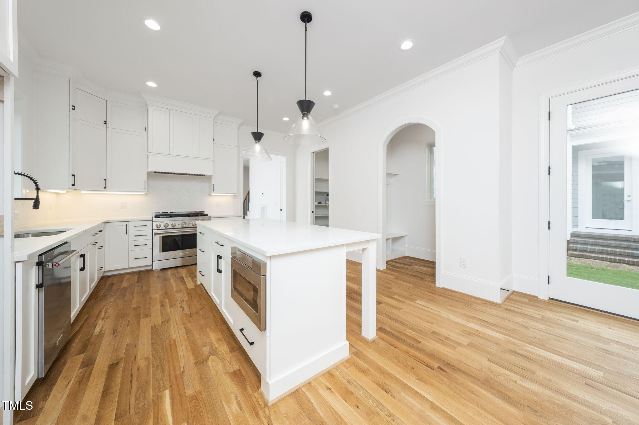 1330 Duplin Road Raleigh, NC 27607 - Photo 20 of 53 a large kitchen with stainless steel appliances granite countertop a sink a stove a refrigerator and a wooden floor