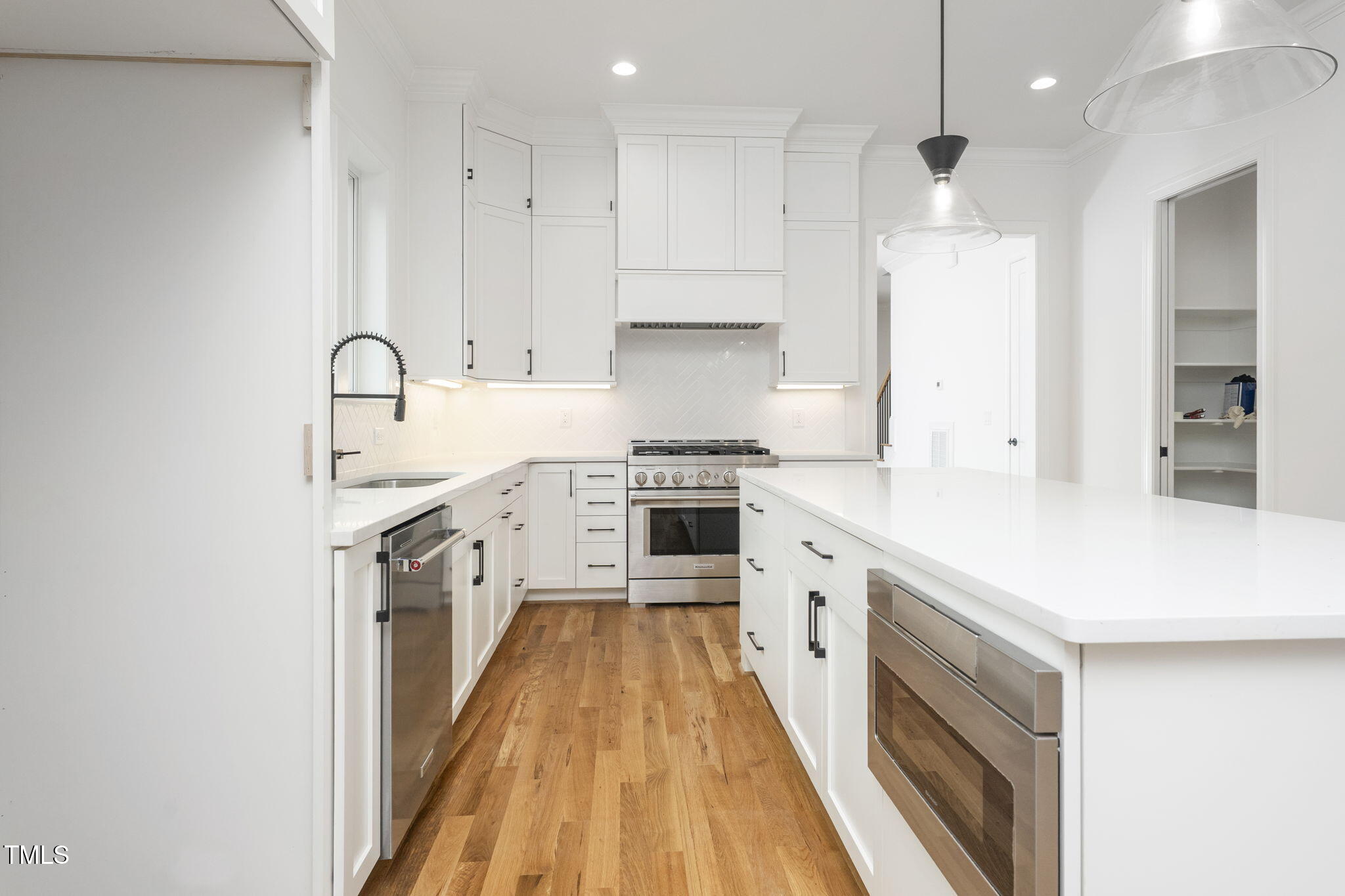 1330 Duplin Road Raleigh, NC 27607 - Photo 21 of 53 an open white kitchen with stove and refrigerator