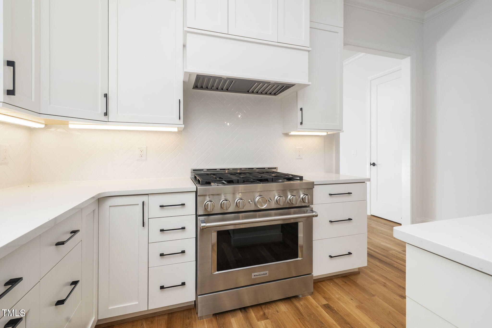 1330 Duplin Road Raleigh, NC 27607 - Photo 23 of 53 a kitchen with granite countertop white cabinets and white appliances