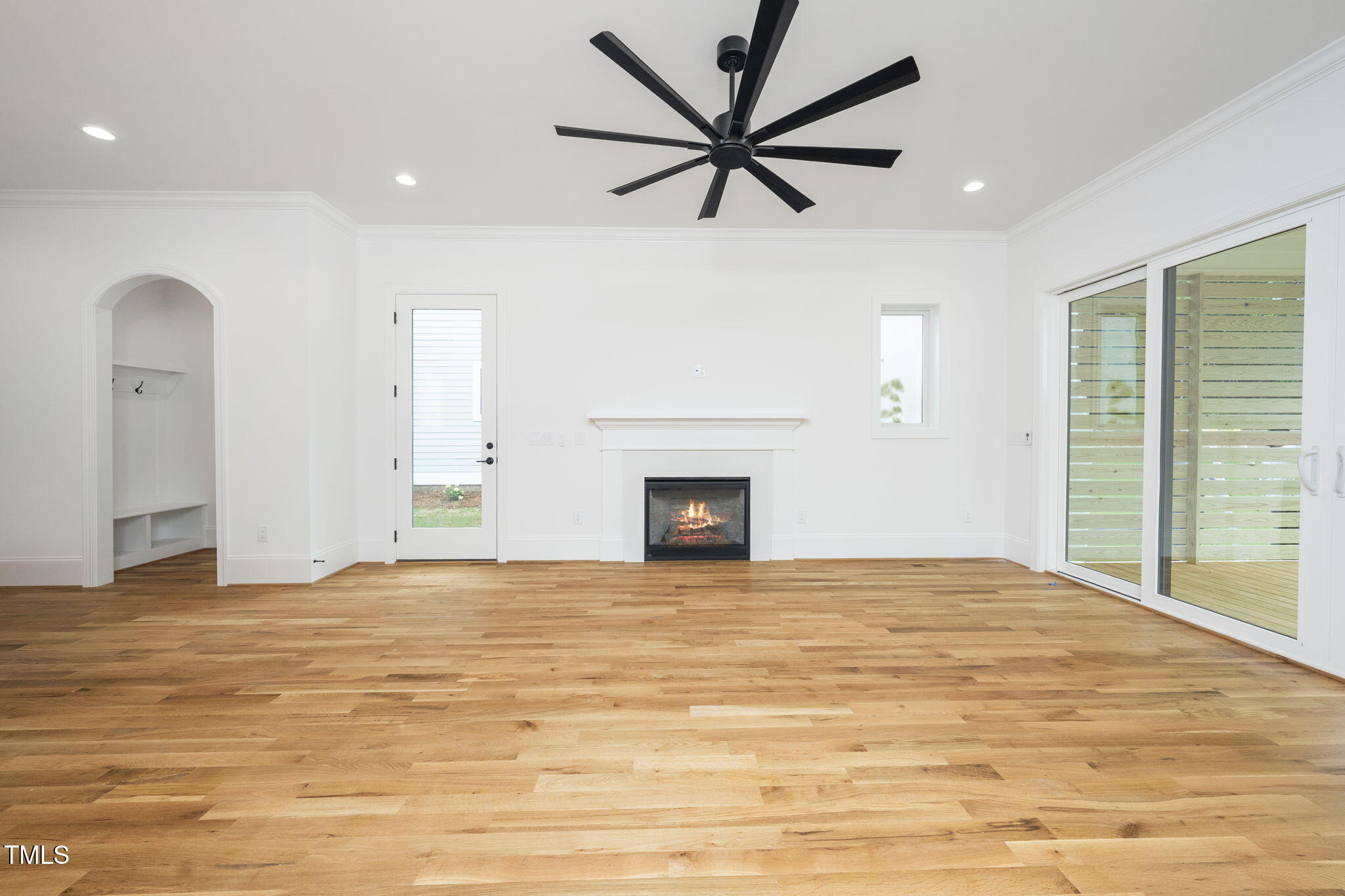 1330 Duplin Road Raleigh, NC 27607 - Photo 27 of 53 a view of a livingroom with a fireplace a ceiling fan and wooden floor