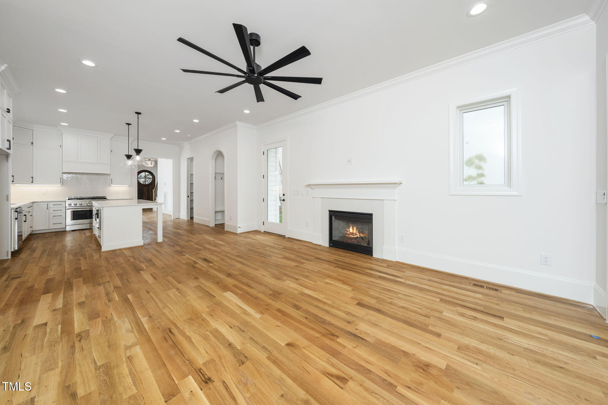 1330 Duplin Road Raleigh, NC 27607 - Photo 28 of 53 a view of a livingroom with a fireplace a ceiling fan and wooden floor