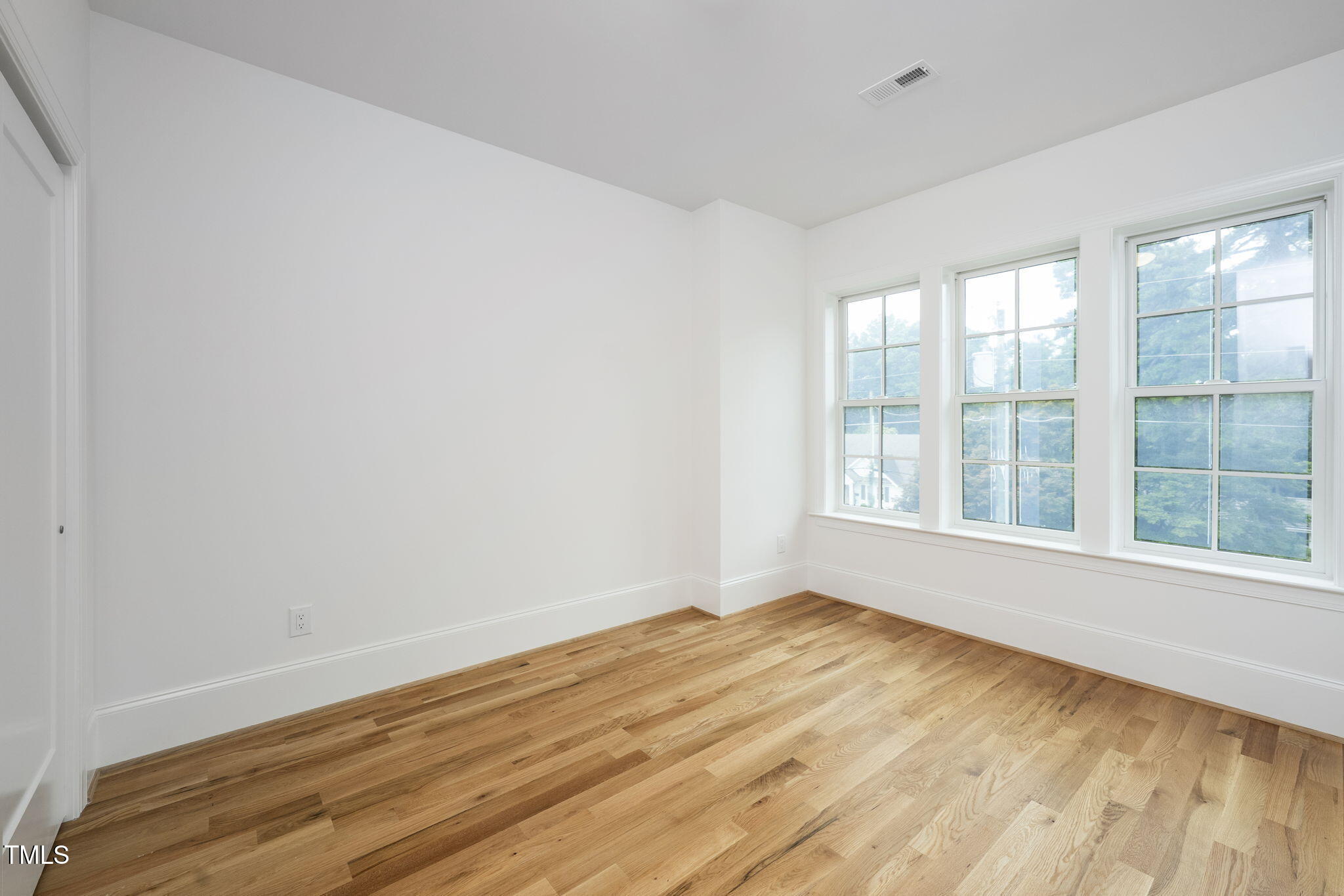 1330 Duplin Road Raleigh, NC 27607 - Photo 33 of 53 a view of an empty room with wooden floor and a window