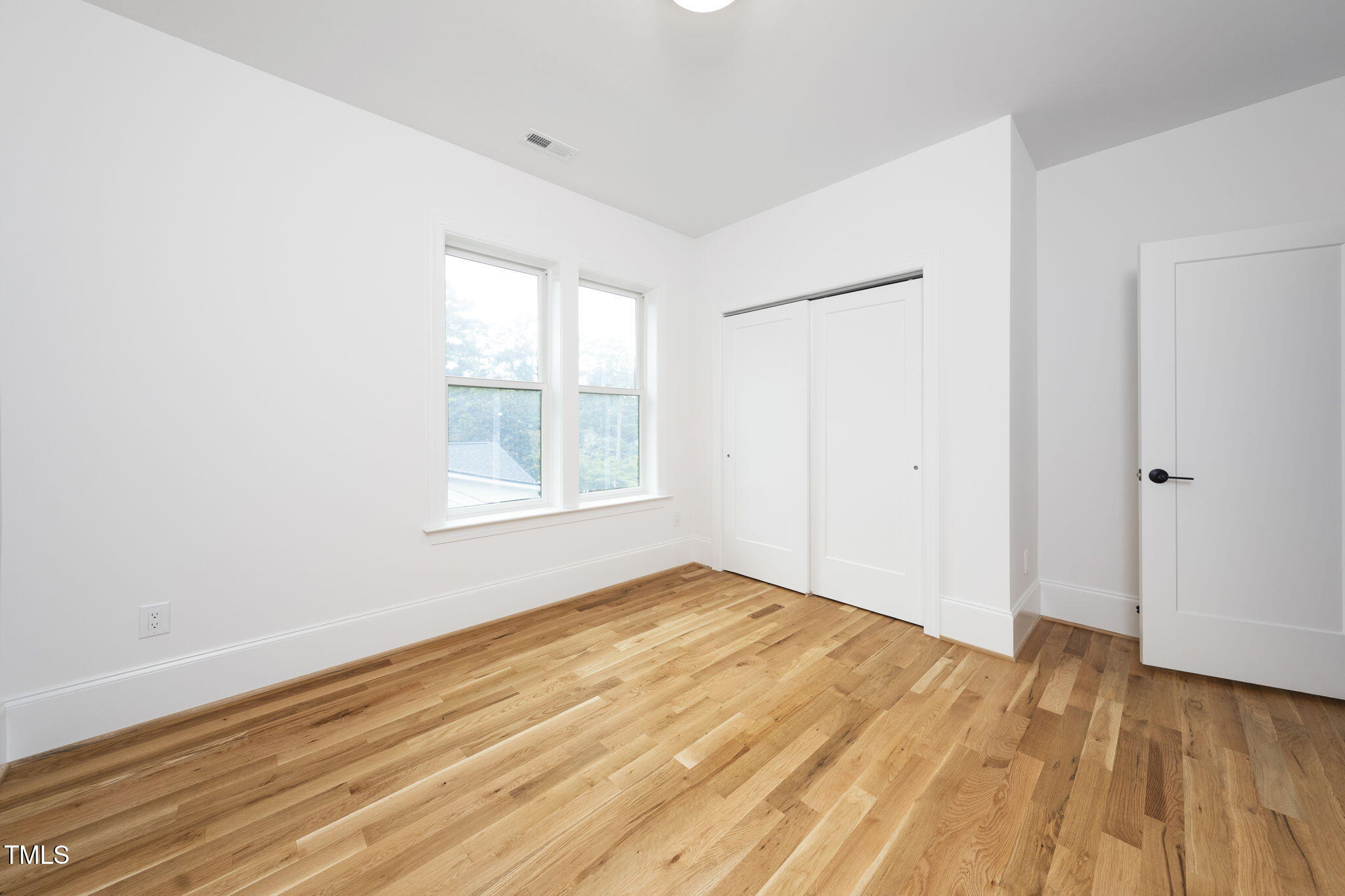 1330 Duplin Road Raleigh, NC 27607 - Photo 35 of 53 an empty room with wooden floor and windows