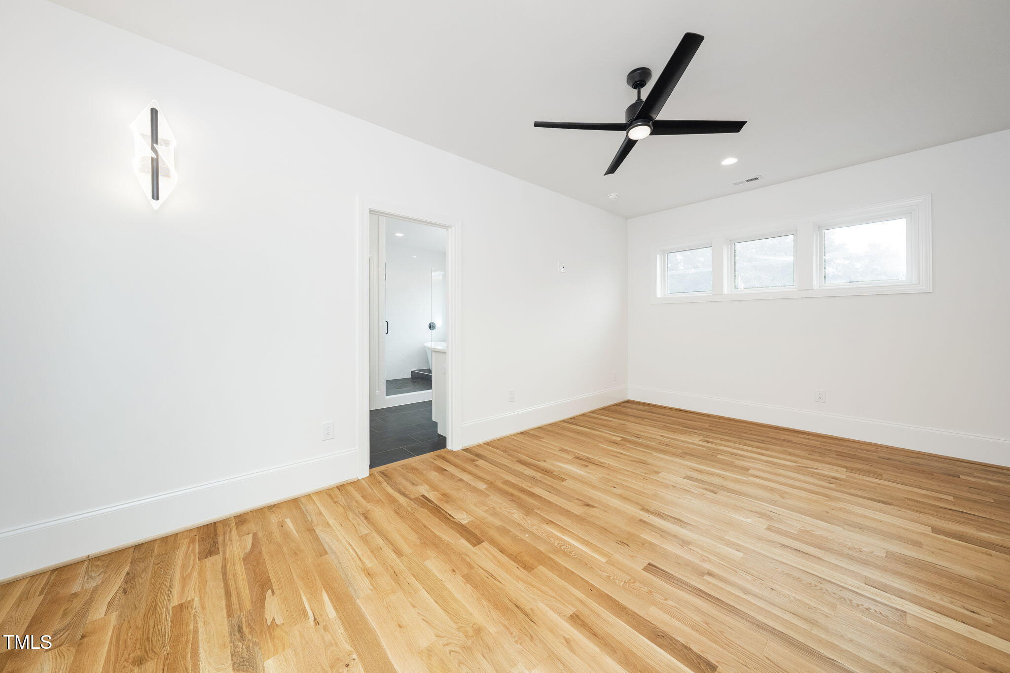1330 Duplin Road Raleigh, NC 27607 - Photo 36 of 53 a bedroom with a bed and a ceiling fan