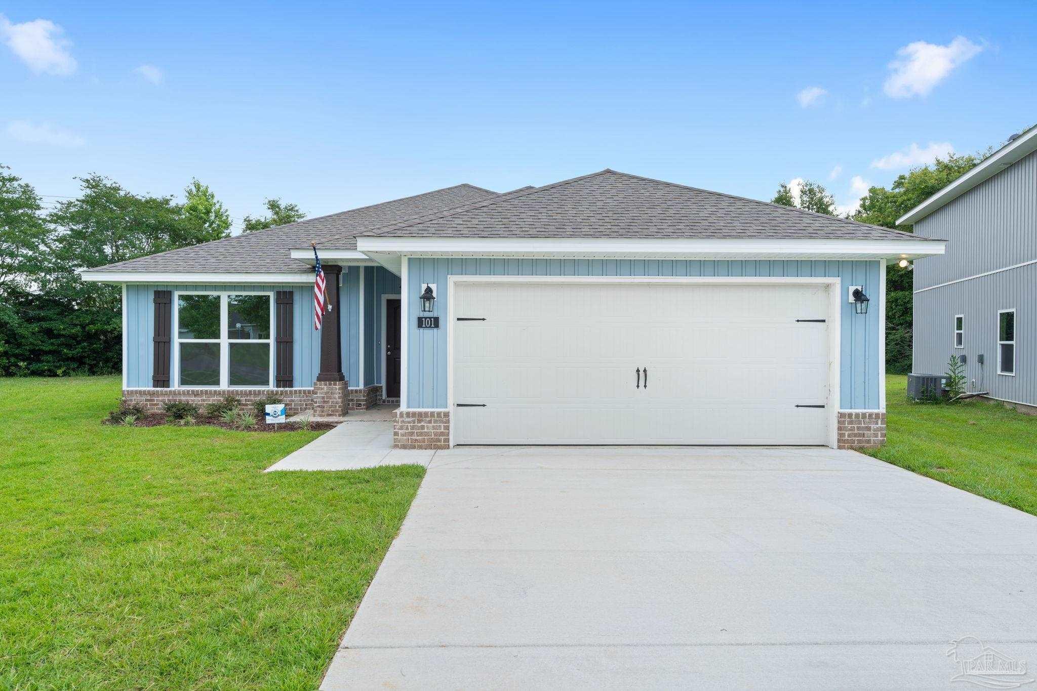 a front view of house with yard and green space