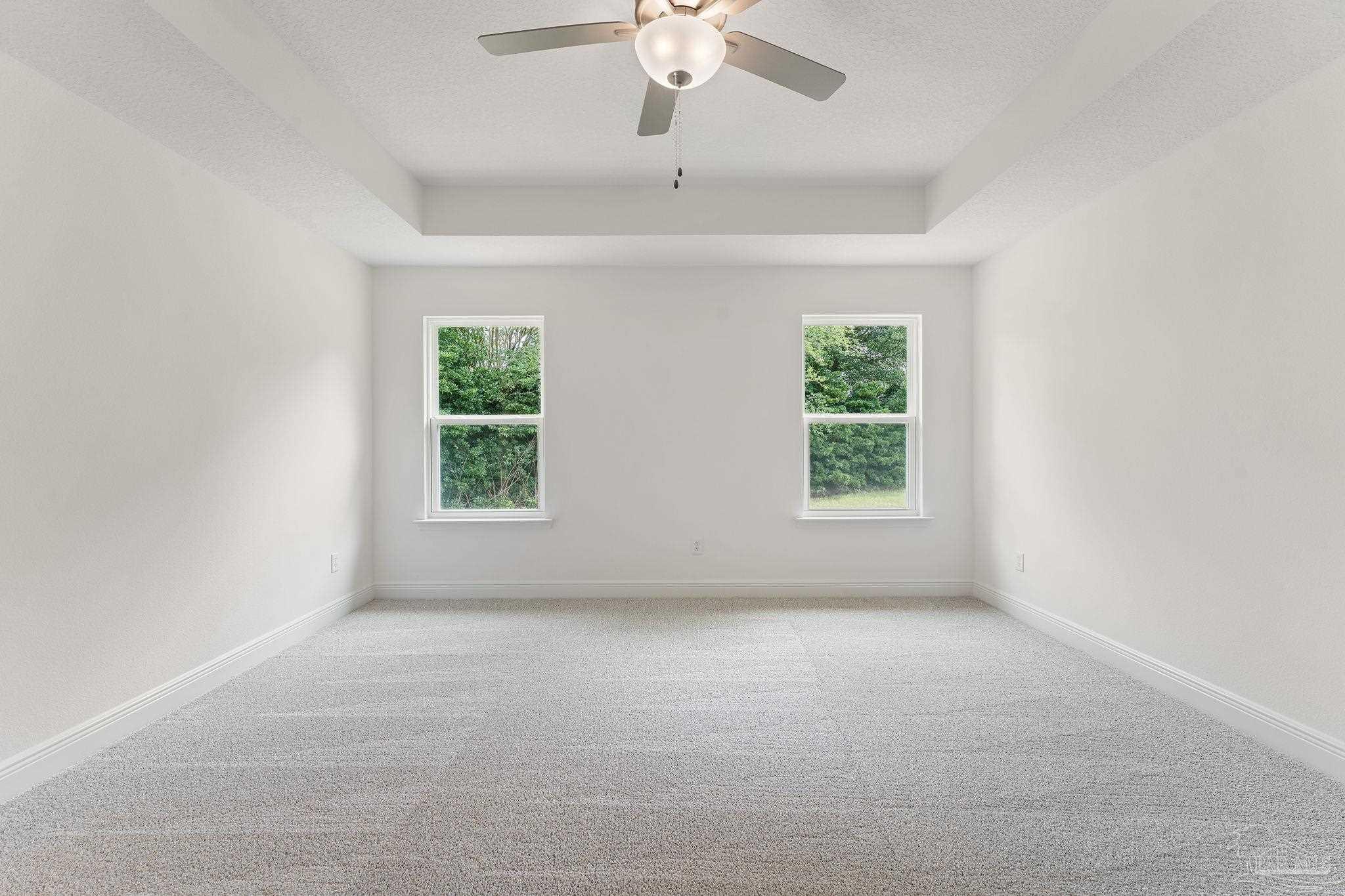 4930 East Spencer Field Road Pace, FL 32571 - Photo 12 of 28 an empty room with windows and ceiling fan