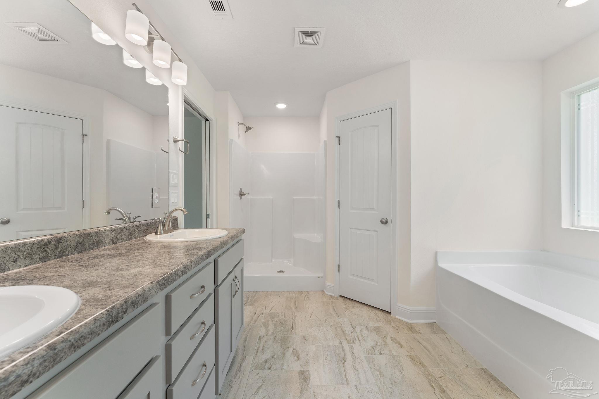 4930 East Spencer Field Road Pace, FL 32571 - Photo 16 of 28 a bathroom with a granite countertop sink and a mirror