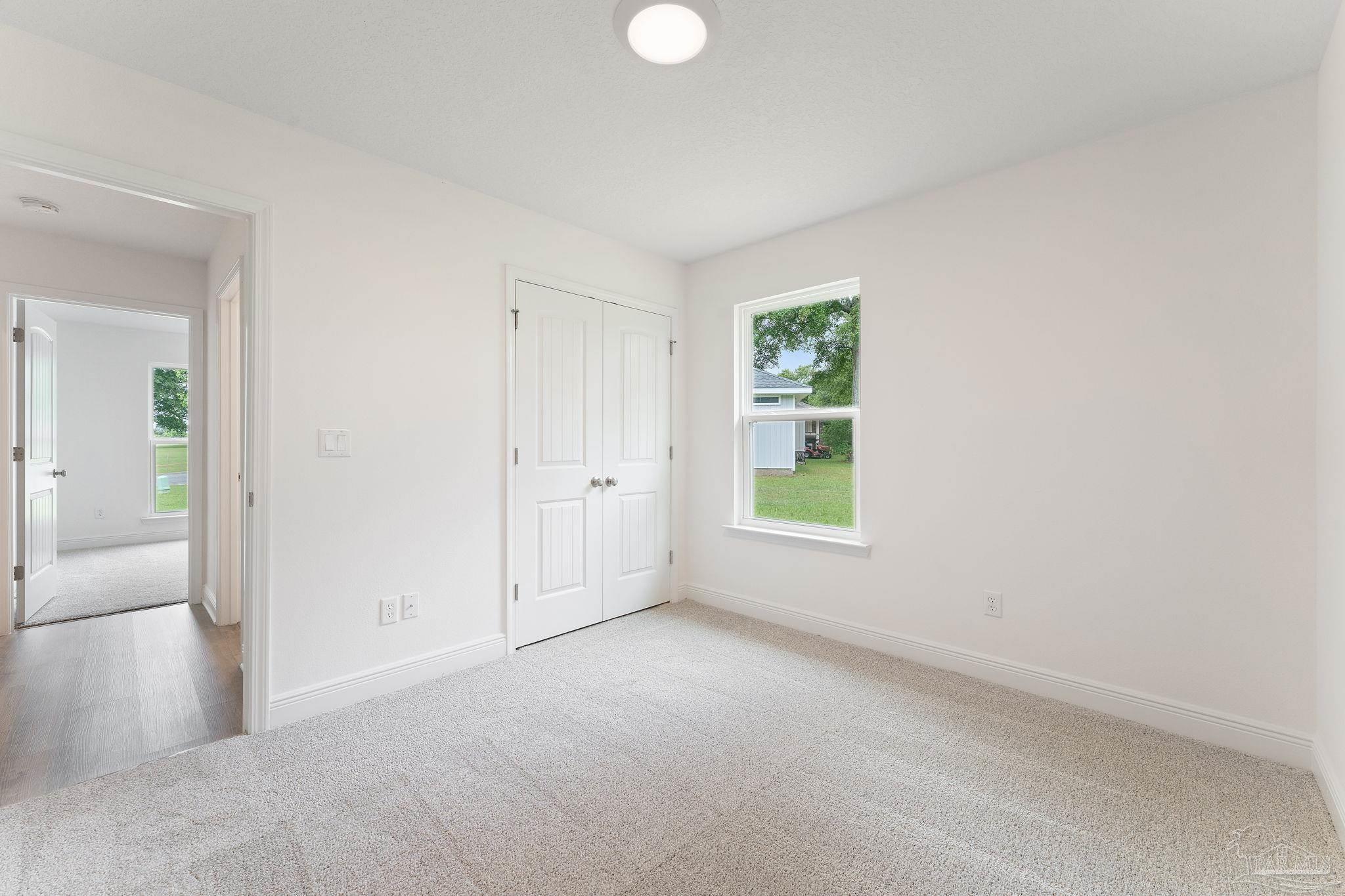 4930 East Spencer Field Road Pace, FL 32571 - Photo 20 of 28 an empty room with windows and closet
