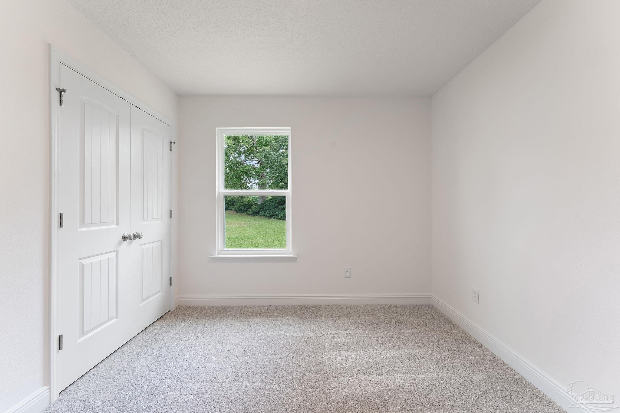 4930 East Spencer Field Road Pace, FL 32571 - Photo 21 of 28 an empty room with a window