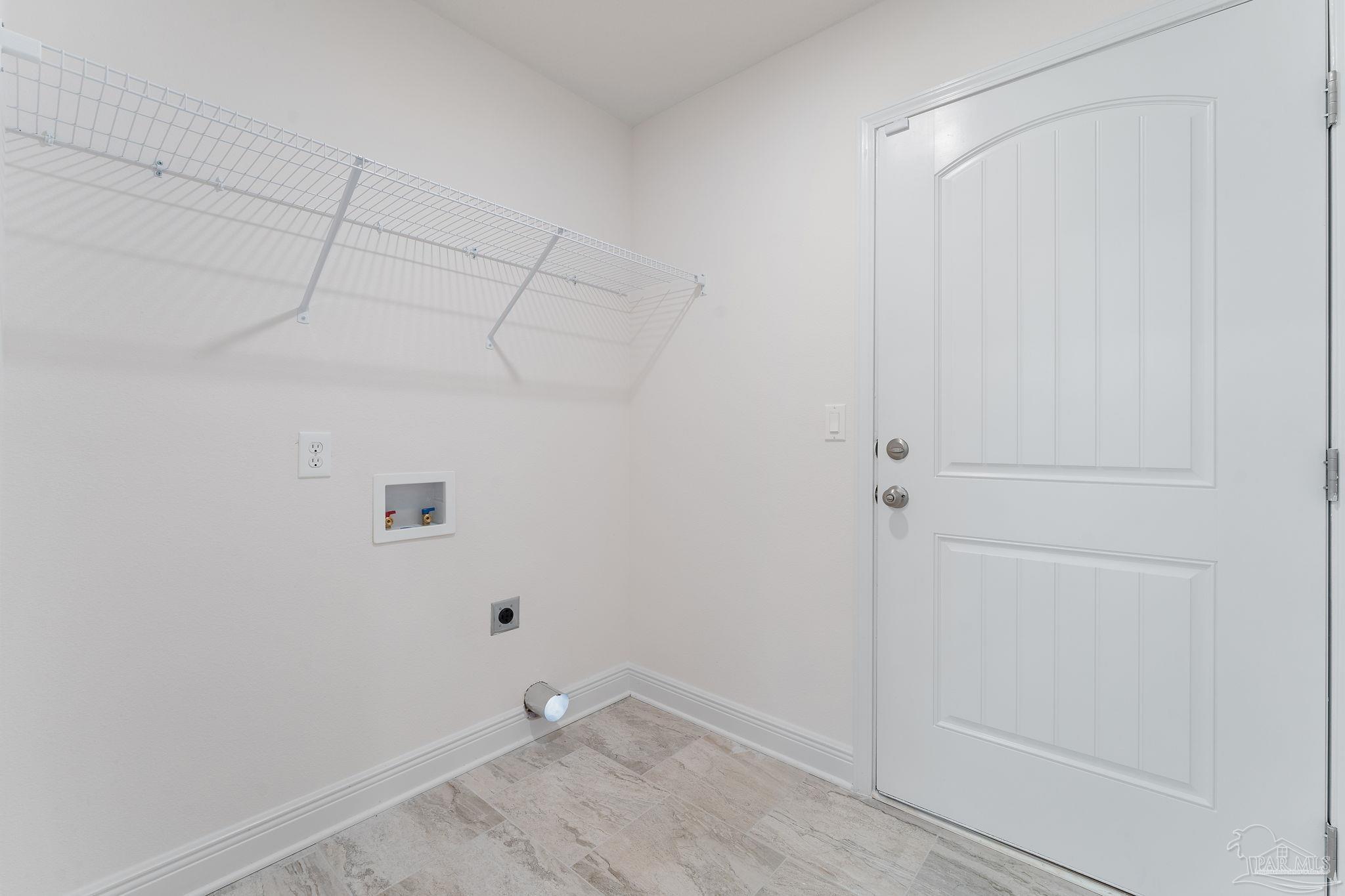 4930 East Spencer Field Road Pace, FL 32571 - Photo 22 of 28 a view of a room with racks on the wall