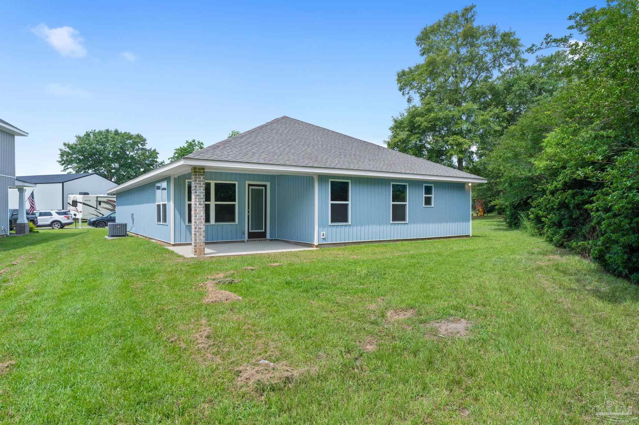 4930 East Spencer Field Road Pace, FL 32571 - Photo 26 of 28 a view of a house with a backyard