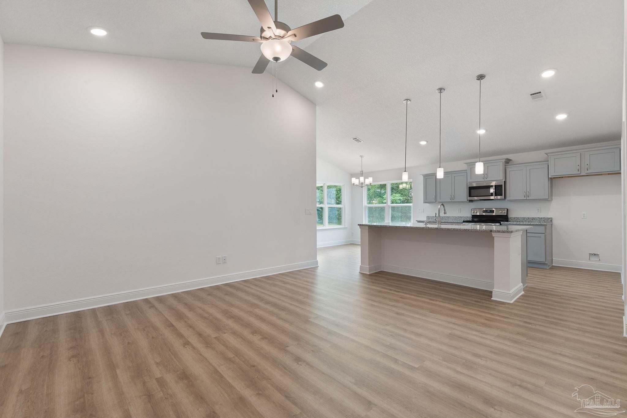 4930 East Spencer Field Road Pace, FL 32571 - Photo 27 of 28 a view of kitchen with wooden floor and window