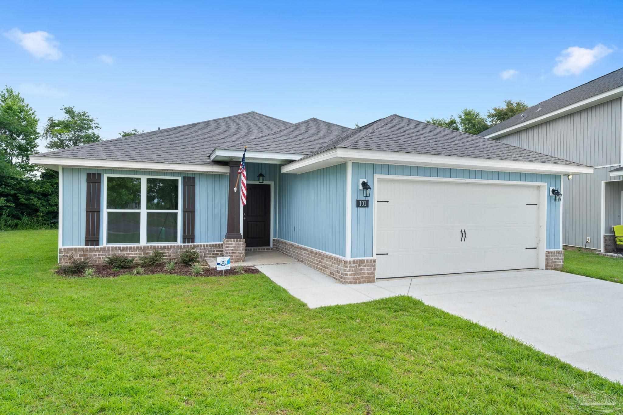 4930 East Spencer Field Road Pace, FL 32571 - Photo 28 of 28 a front view of a house with a yard and garage