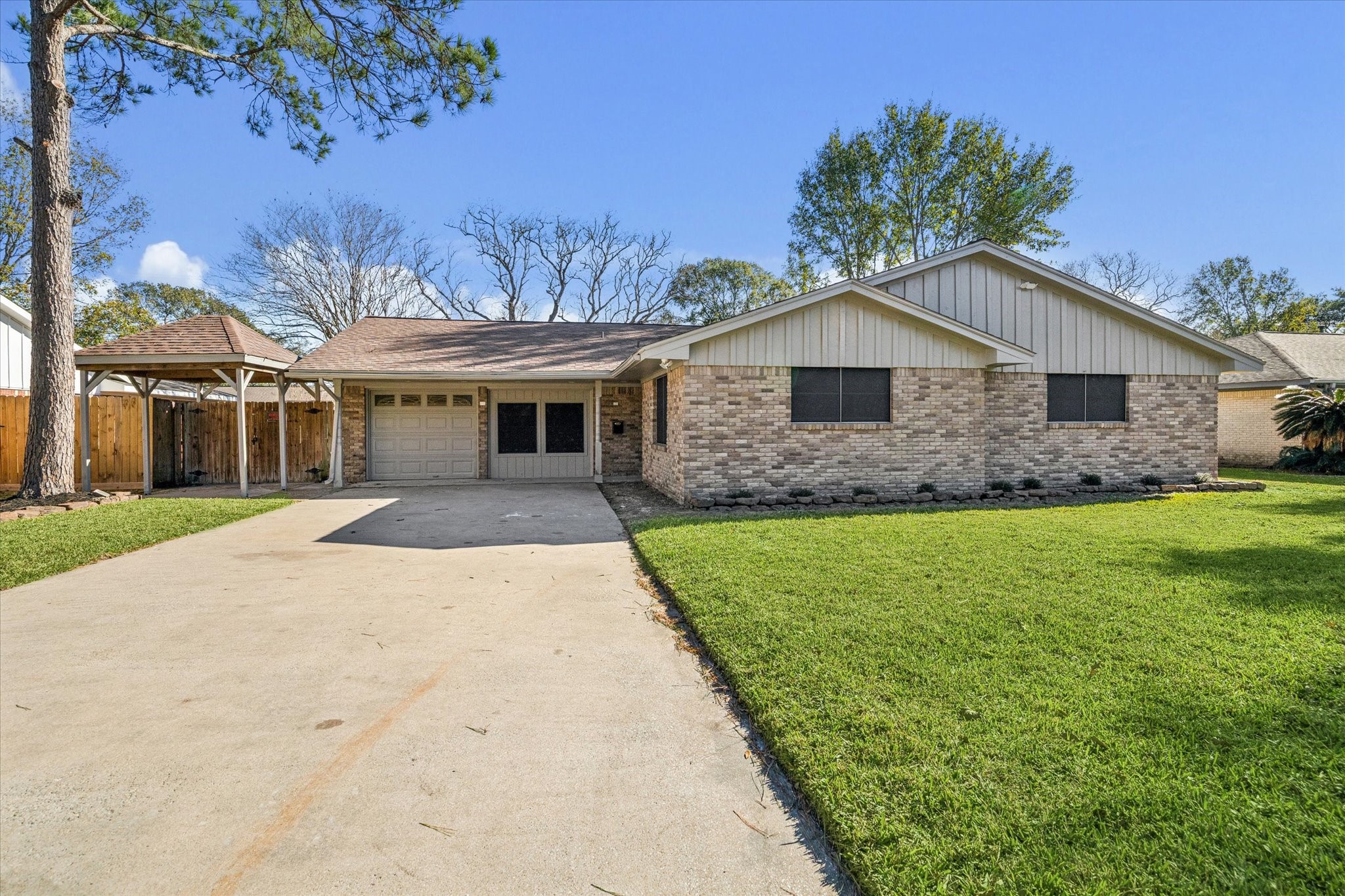 1703 Raintree Drive Baytown, TX 77520 - Photo 1 of 17 a front view of a house with a garden