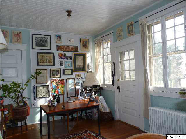 1934 Lewis Mountain Road Charlottesville, VA 22903 - Photo 16 of 32 Busy writer's office currently at one end of the sunroom.
