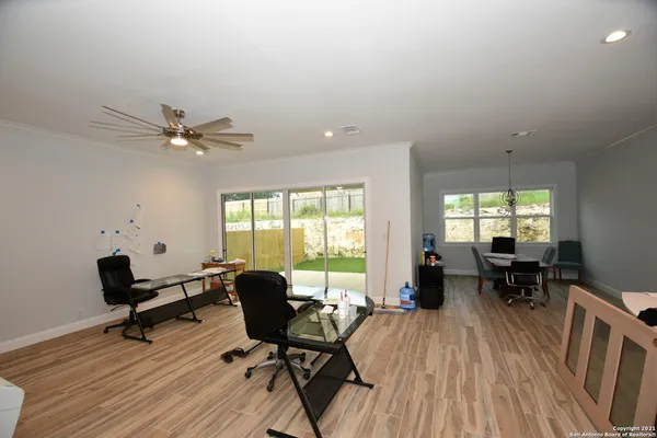 a workspace with wooden floor and a window