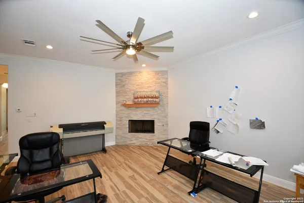 a workspace with furniture and a ceiling fan
