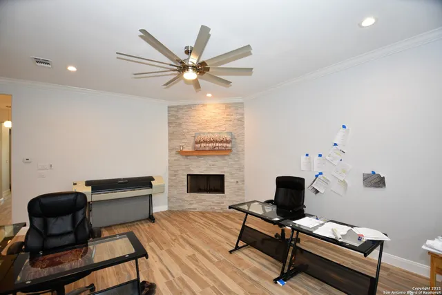 a workspace with furniture and a ceiling fan