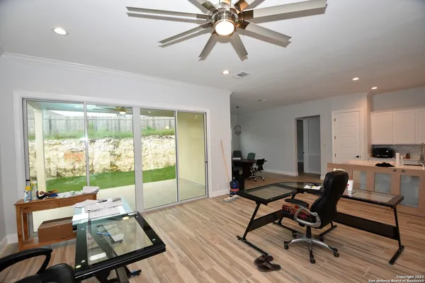 a workspace with wooden floor and a window