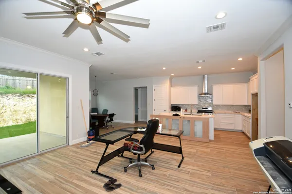 a living room with furniture and a wooden floor