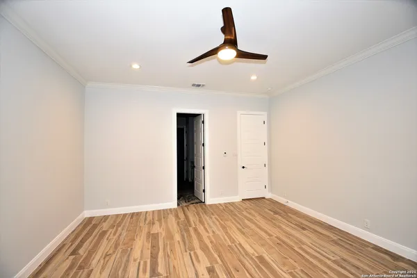a view of empty room with wooden floor