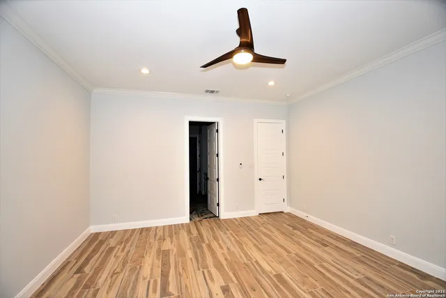 a view of empty room with wooden floor