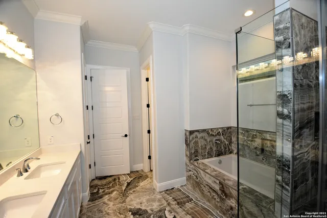 a bathroom with a tub sink and shower