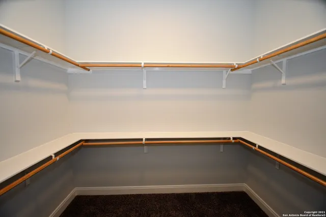 a bathroom with a sink mirror and a shower