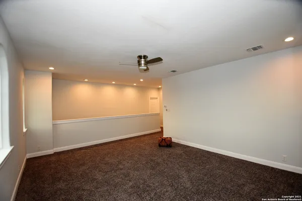 an empty room with a empty space and windows