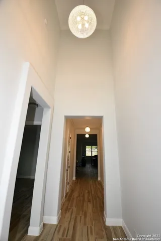 a view of a hallway with wooden floor