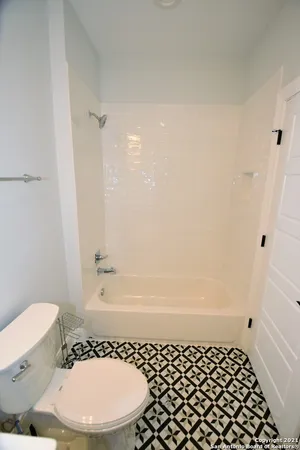 a bathroom with a sink toilet and mirror
