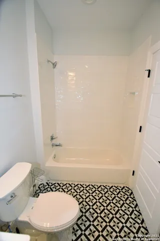 a bathroom with a sink toilet and mirror