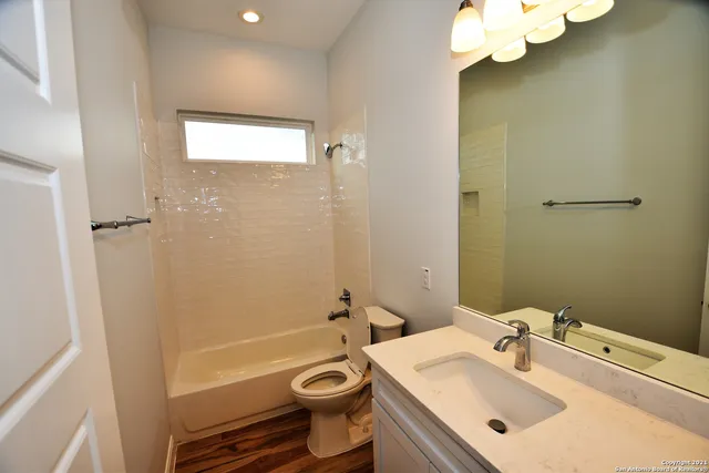 a bathroom with a sink a toilet and bathtub