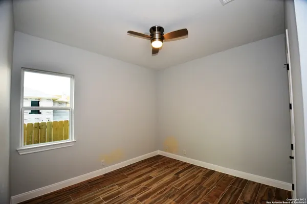 a view of room with window and wooden floor