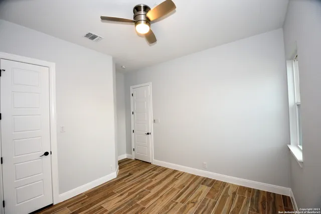 a view of room with window and wooden floor